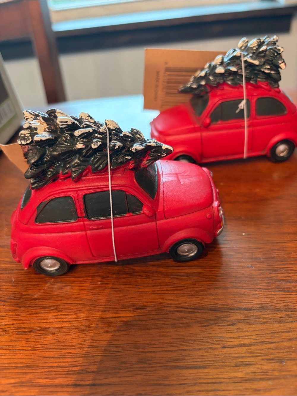 Set of 2 red cars with Xmas tree on top.